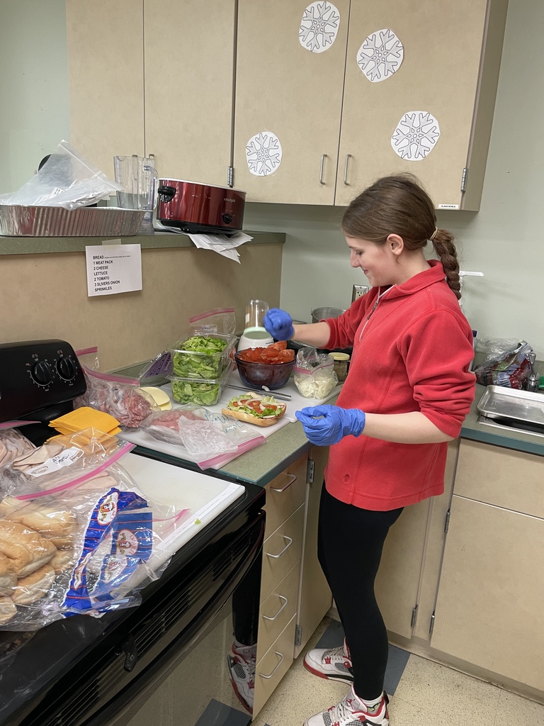 Student making food for teachers