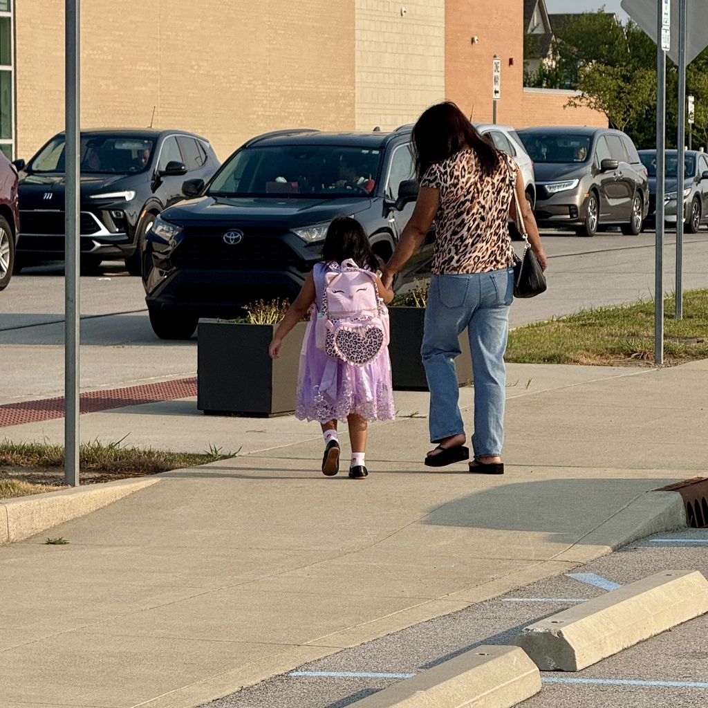 Mom and daughter going into school