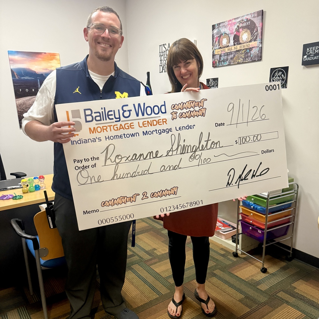 Justin and Roxanne with the big check