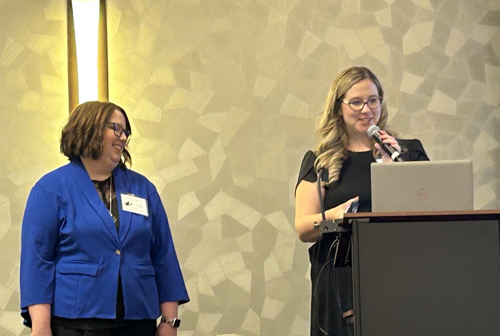 Lorrie smiling receiving award