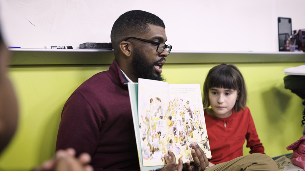 Timothy Pritchett reading with students