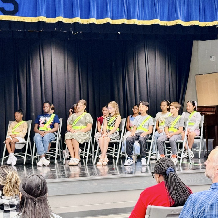 safety patrol members sit on stage
