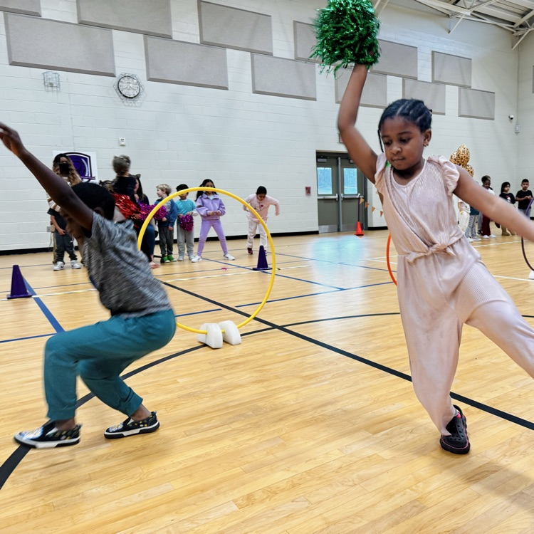 students dancing to their den