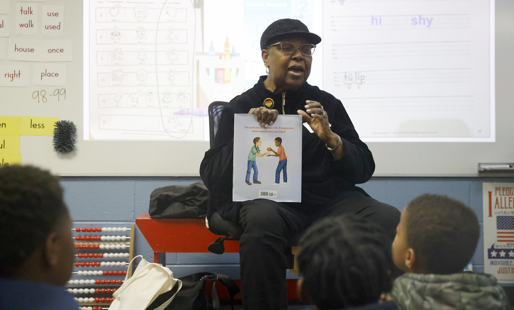 Woman reading to students