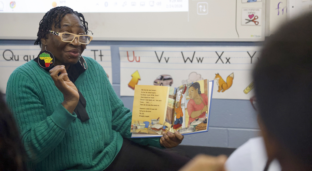 Woman reading to students