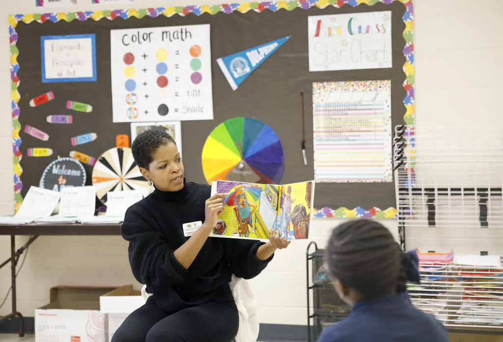 Woman reading to students