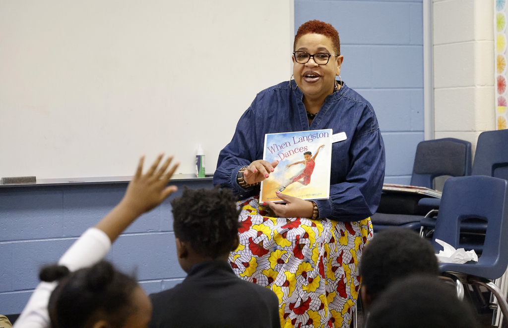 Woman reading to students