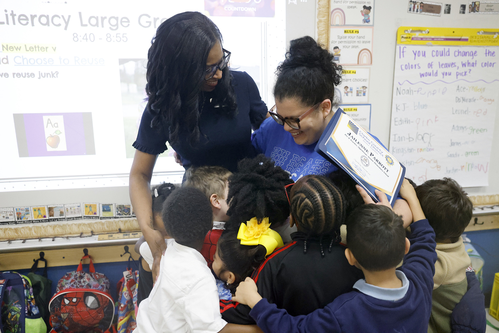 Ms. Parrott and Dr. Scott hugging students