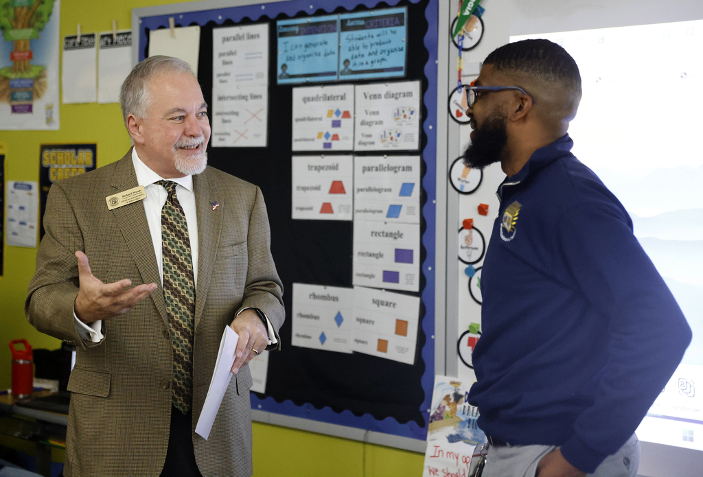 Pritchett speaking with Woods