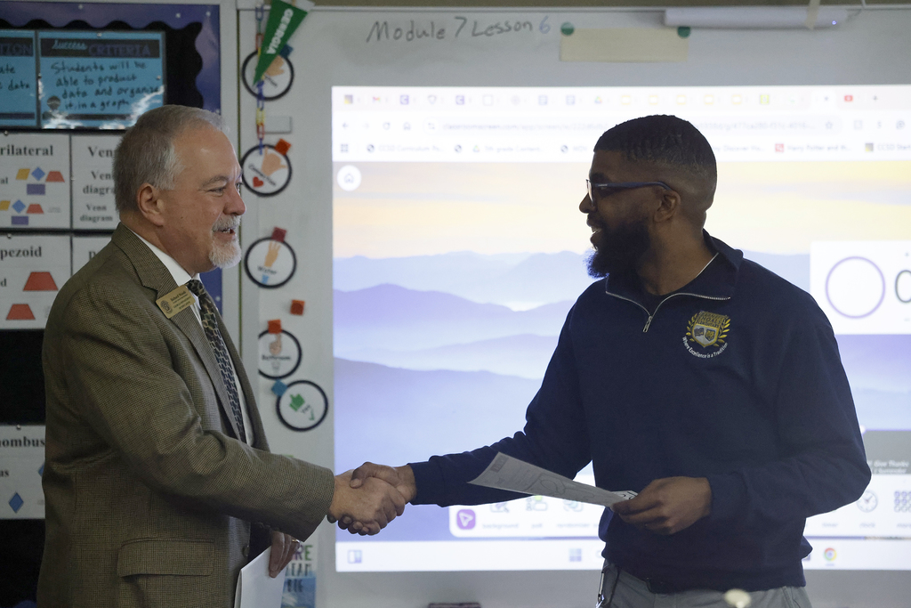 Pritchett shaking hands with Woods