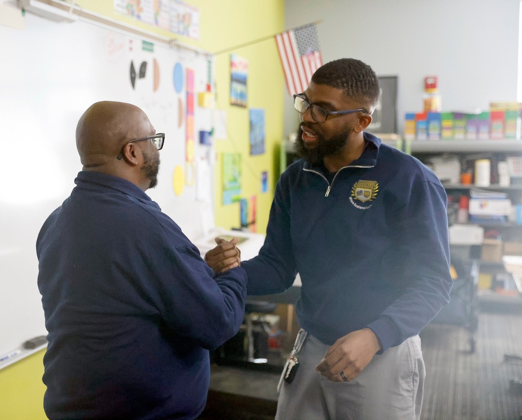  Teacher of the year receiving congratulations from peer 