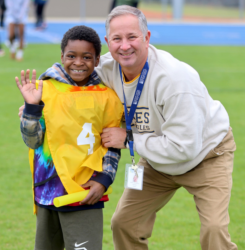 Student and teacher smiling
