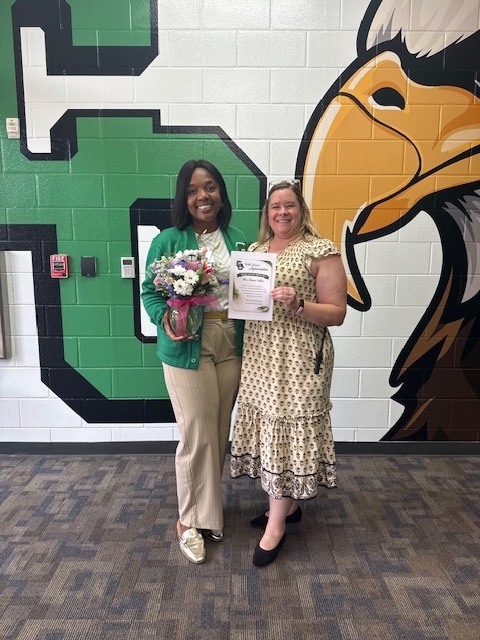 Ms. Sellers and Ms. Draper pictured with flowers and a thank you certificate