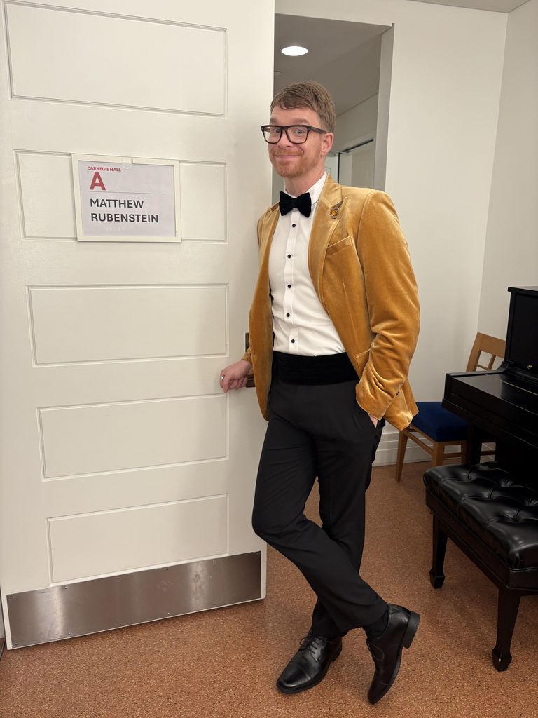 A photo of Mr. Rubenstein, our BHL Orchestra and Guitar teacher. He has been appointed by the FMEA to serve as Orchestra Chair for District 14. He is wearing a tuxedo . 