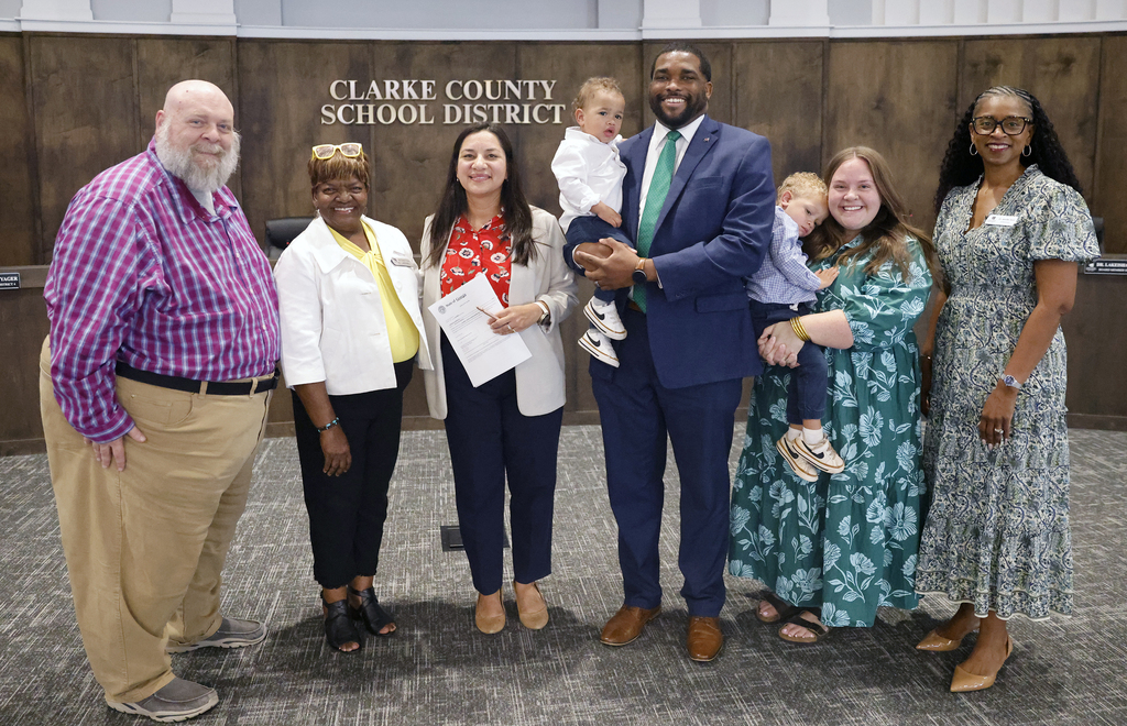 Johnelle Simpson with family, judge, school board members, and Superintendent