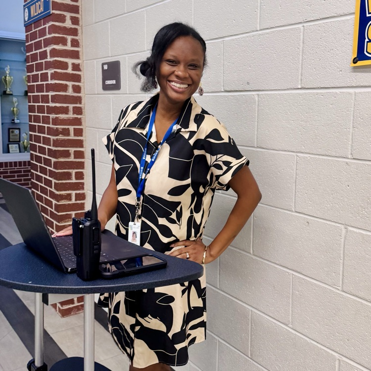 a staff member poses in the hallway