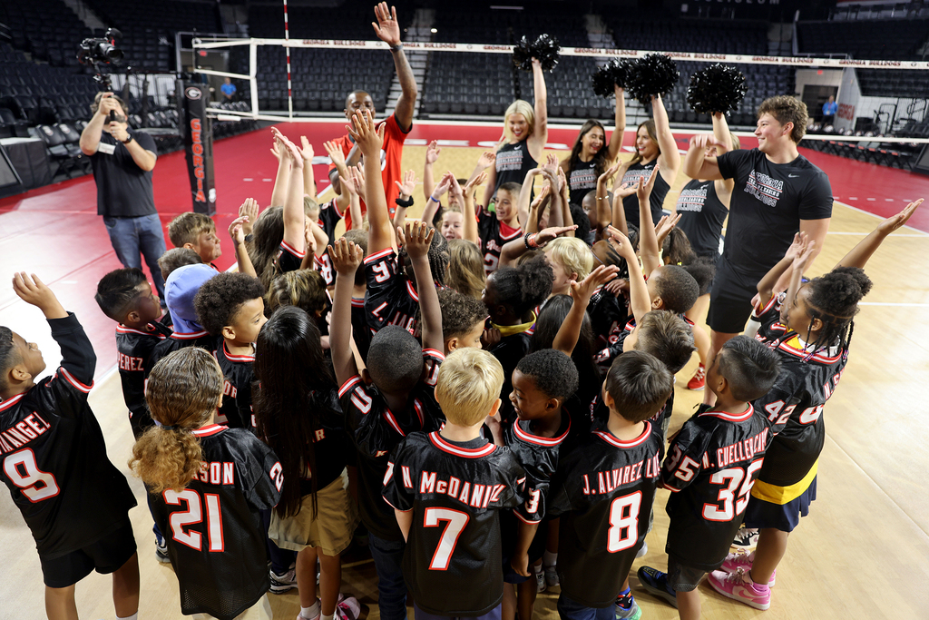 Group of students with Malcolm Mitchell and UGA cheerleaders