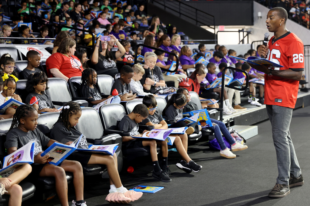 Malcolm Mitchell reading with group of students