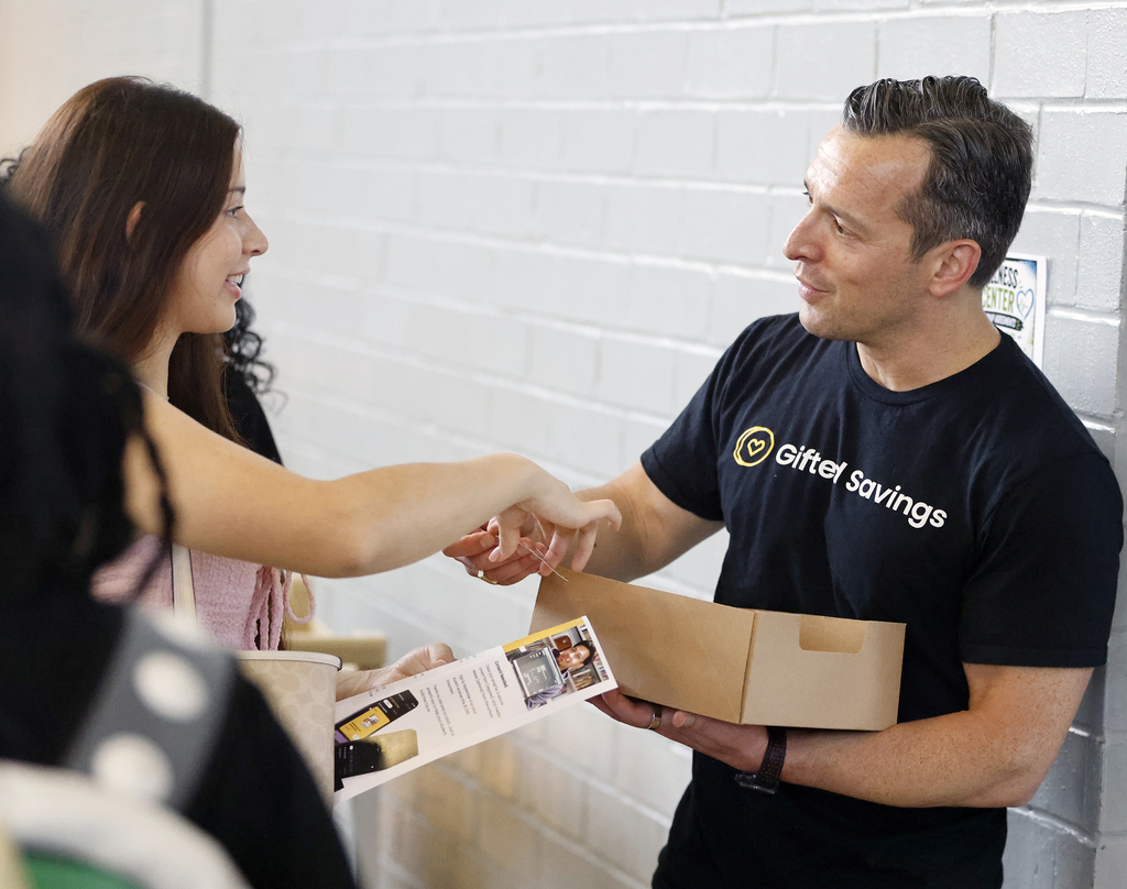 Gifted Savings Executive Director shaking hands with student