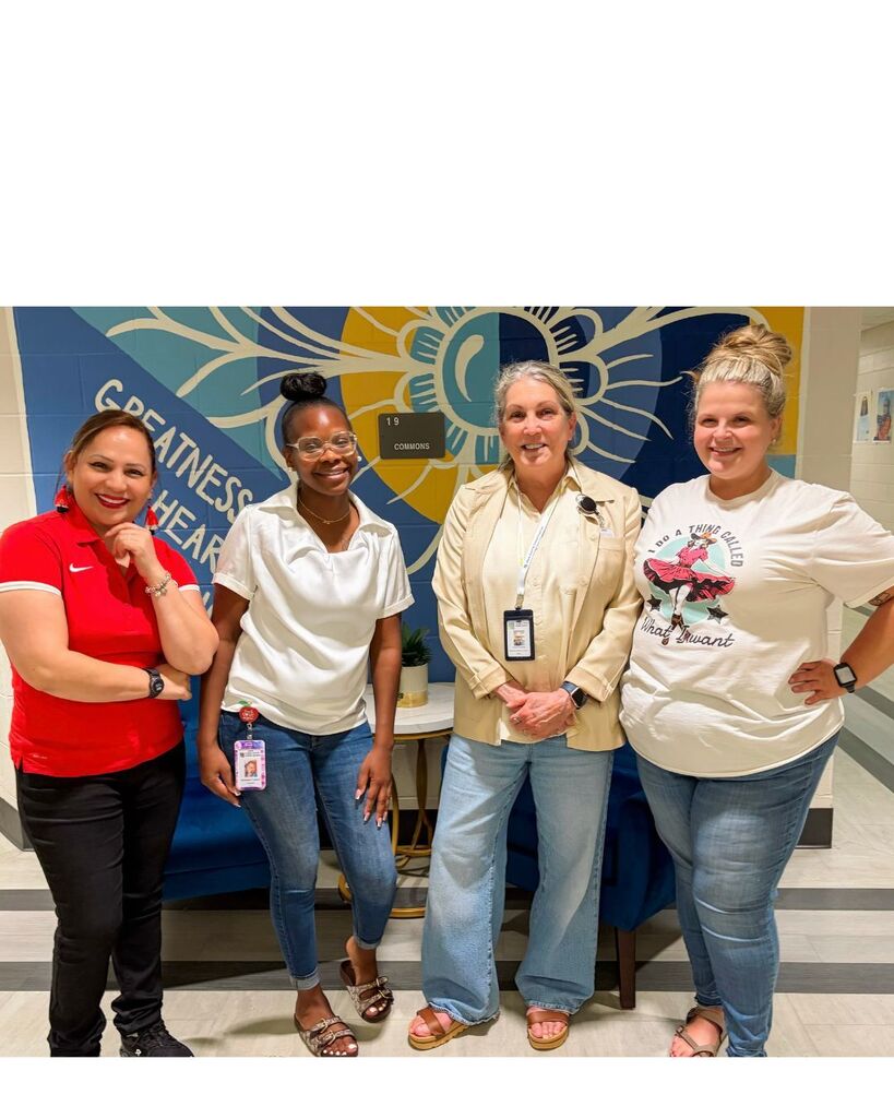 An image of all the nominees at BHL for Support Professional of the year. The nominees are standing in front of a yellow, blue and white mural that has the word "Greatness" on it. They are wearing casual clothes in a variety of colors. The names are: Sandra Herrera, Deandrea Flemming, Cheryl Hudson, and Courtney Grant. Not pictured is Krystal Littleton.