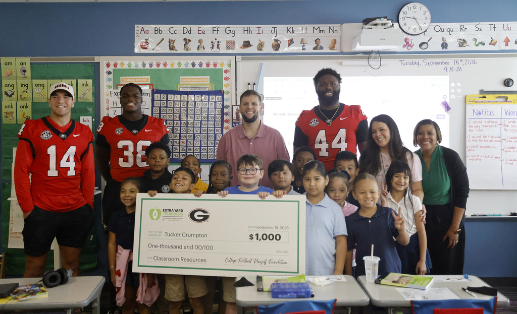 Georgia Football check presentation to teacher Tucker Crumpton and class