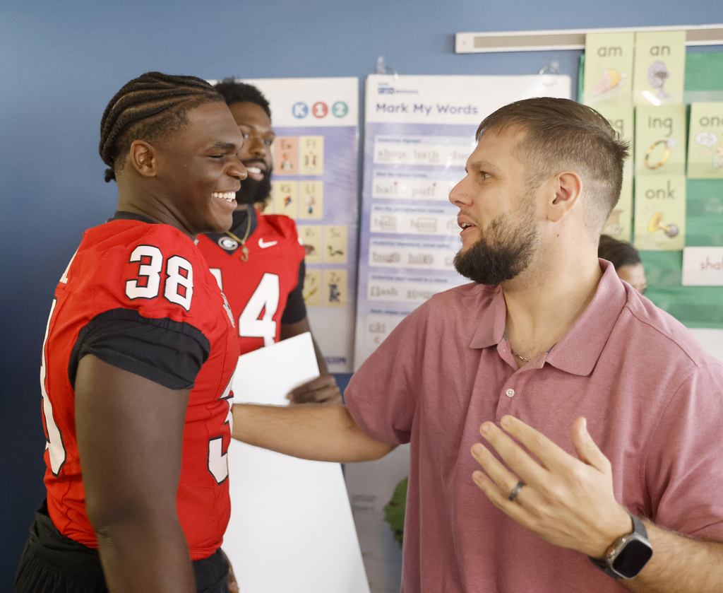 Teacher Tucker Crumpton with Georgia football player AJ Lonon