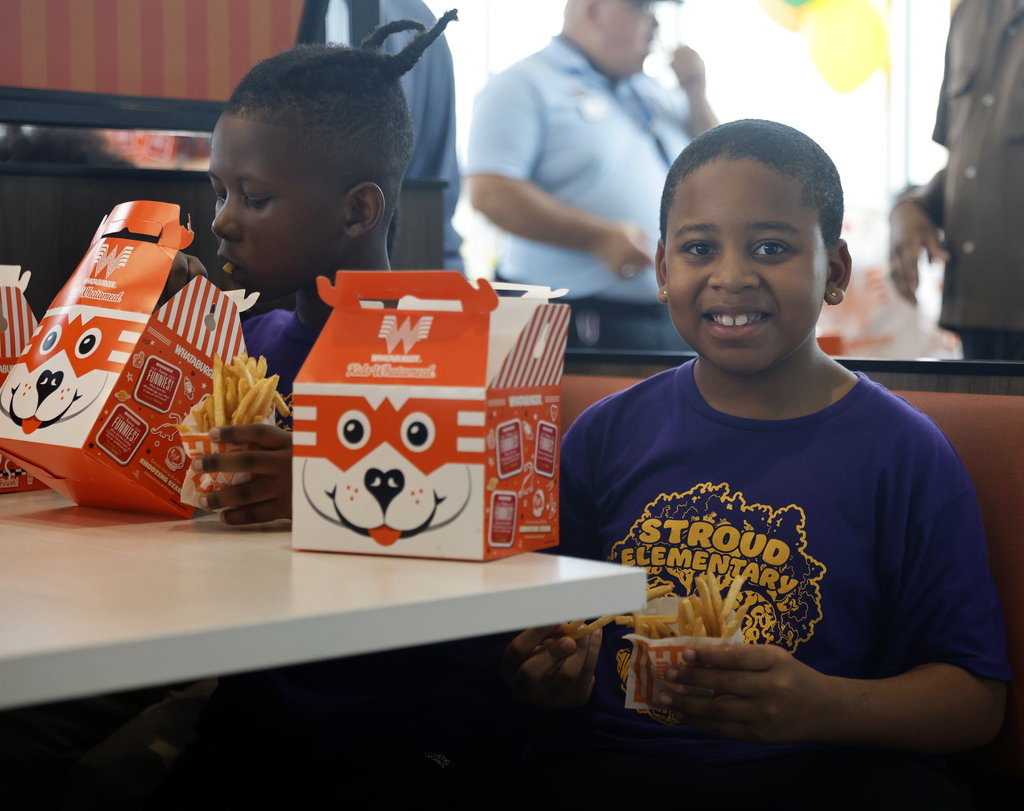 Student smiling while having lunch