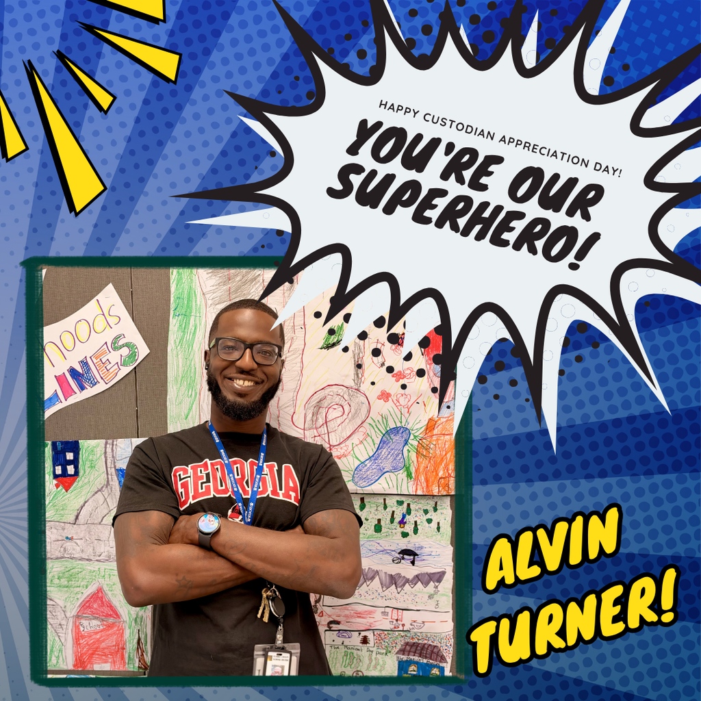 Mr. Alvin poses smiling in front of student artwork