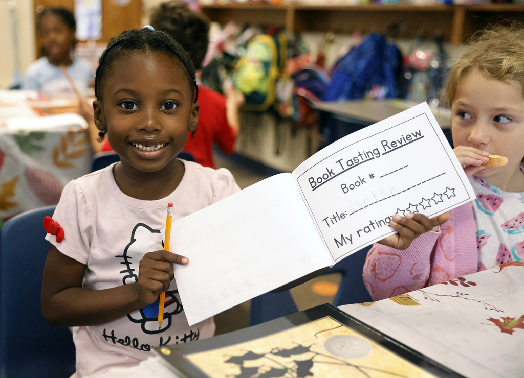 Student holding up worksheet