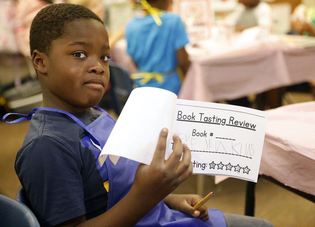 Student holding up worksheet