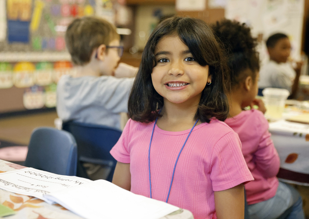 Student looking up from book and smiling