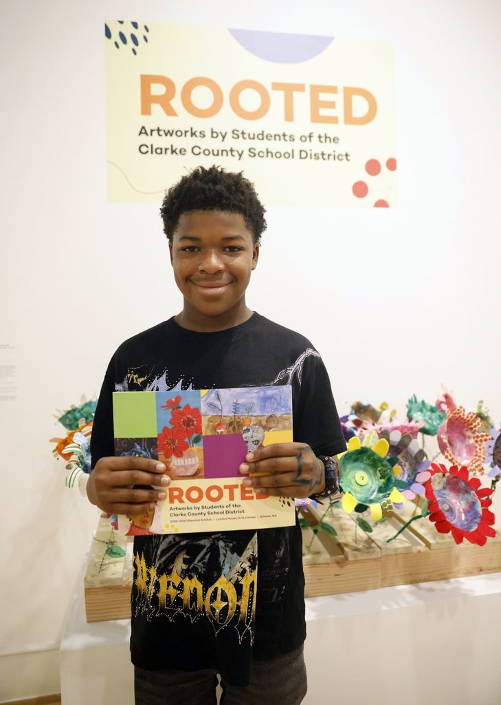 Student holding up art book