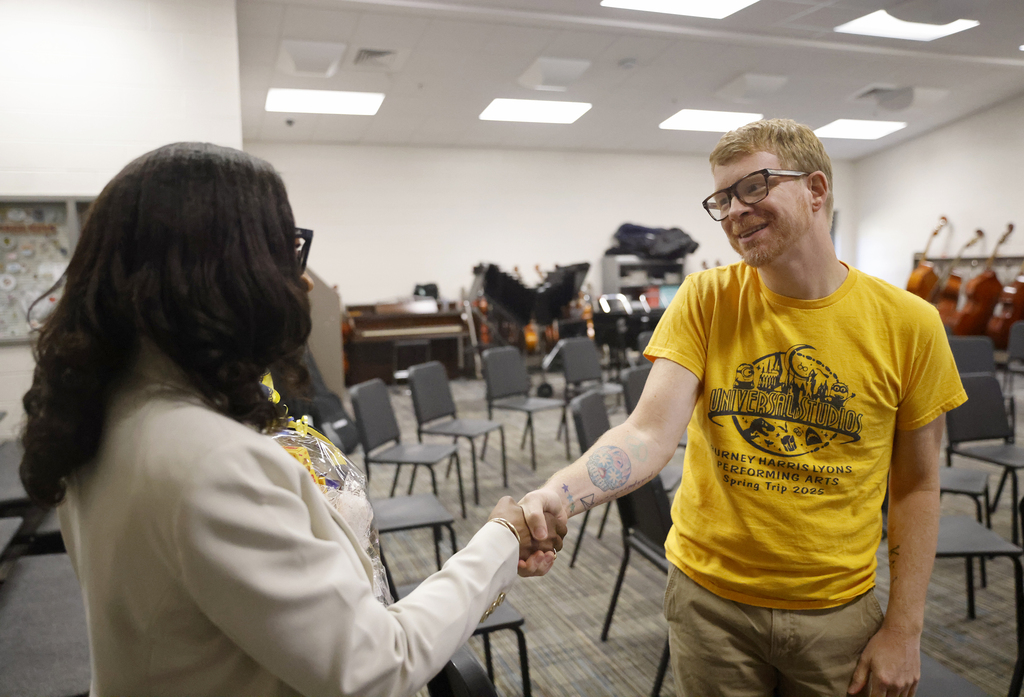 BHL teacher shaking hands with Superintendent