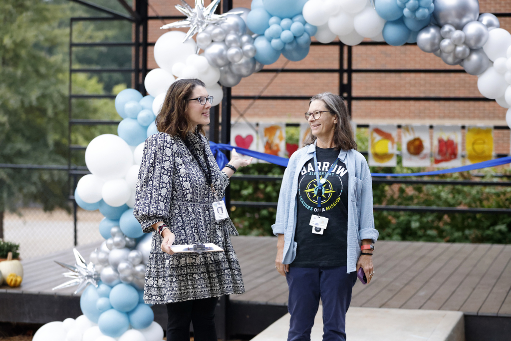 Principal and teacher speaking during ceremony