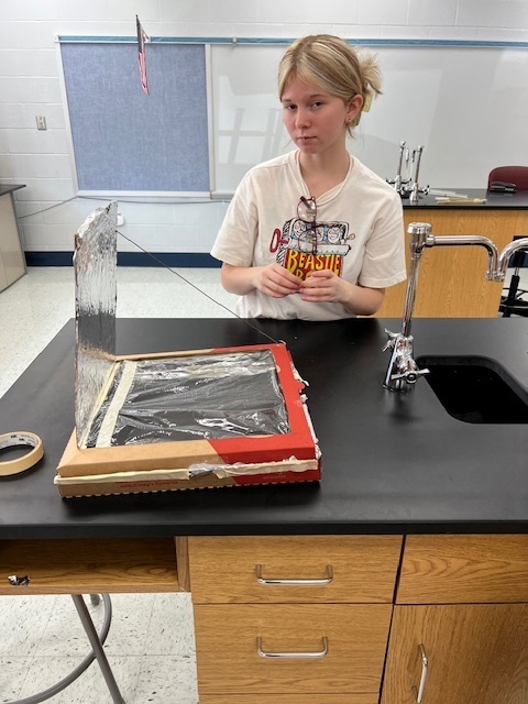 Mr. Brummer’s science class worked on a STEM project to design and build solar ovens this week. They used pizza boxes, foil, plastic wrap, and other materials to create solar ovens that could reach temps of 160 to 200 degrees Fahrenheit! Today they put them to use and made some s’mores using the power of the sun.