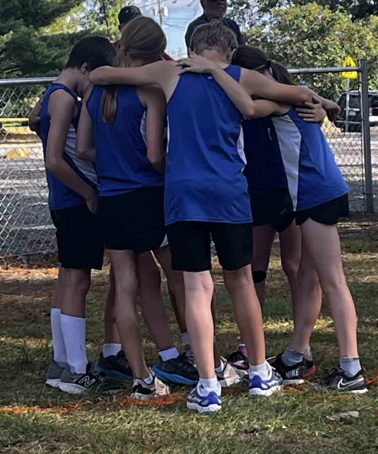 Junior High Cross Country Team in a prayer huddle before the meet