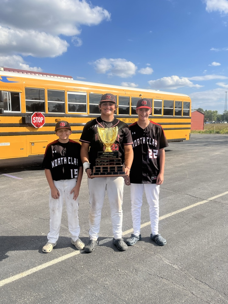 NC/CC HS Baseball Co-op CC teammates freshman James O'Dell, senior Cayden Craig, and freshman Chase Bangert take a moment to pose with their NTC Baseball Championship trophy. They also strike a smile with the rest of the NC/CC HS Baseball team!