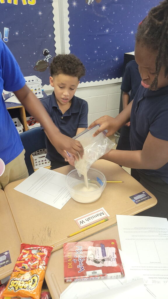 5th Graders investigating rain erosion