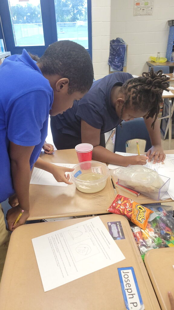 5th Graders investigating rain erosion