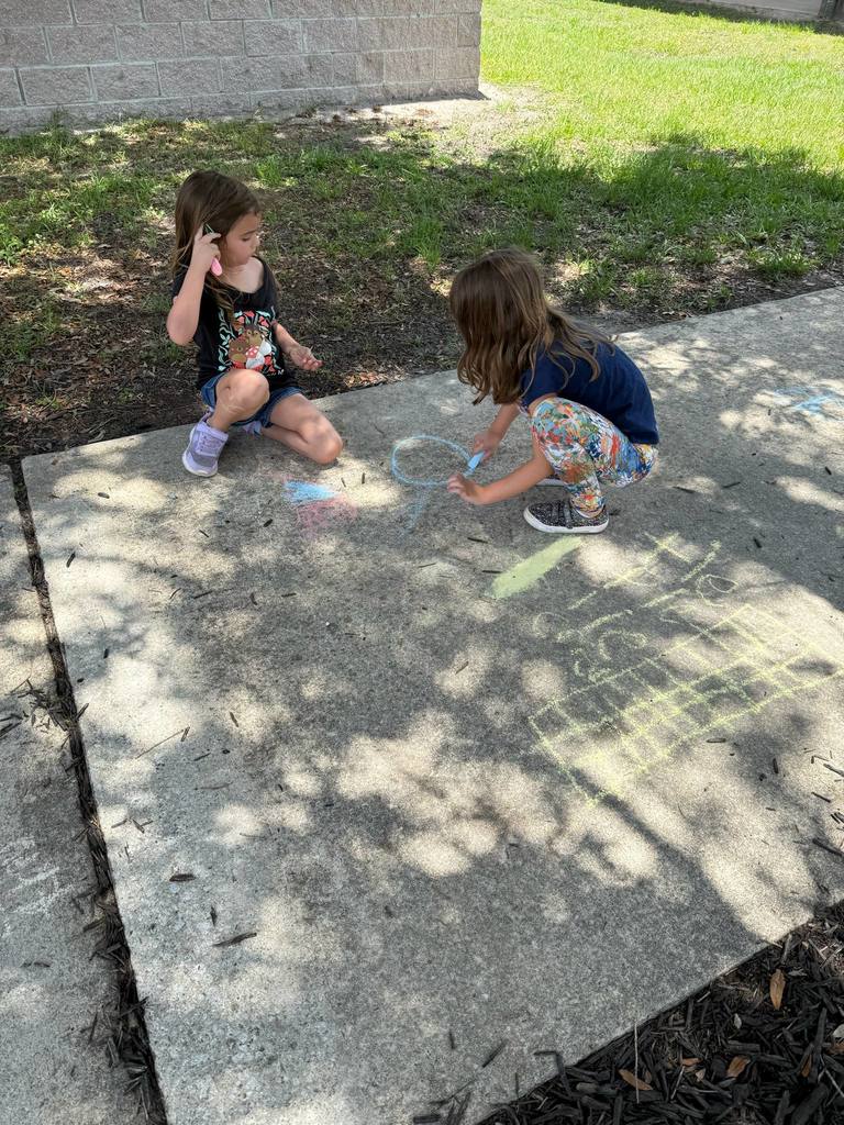 O for outside. First grade took their learning outside yesterday, and they wrote their spelling words with chalk.
