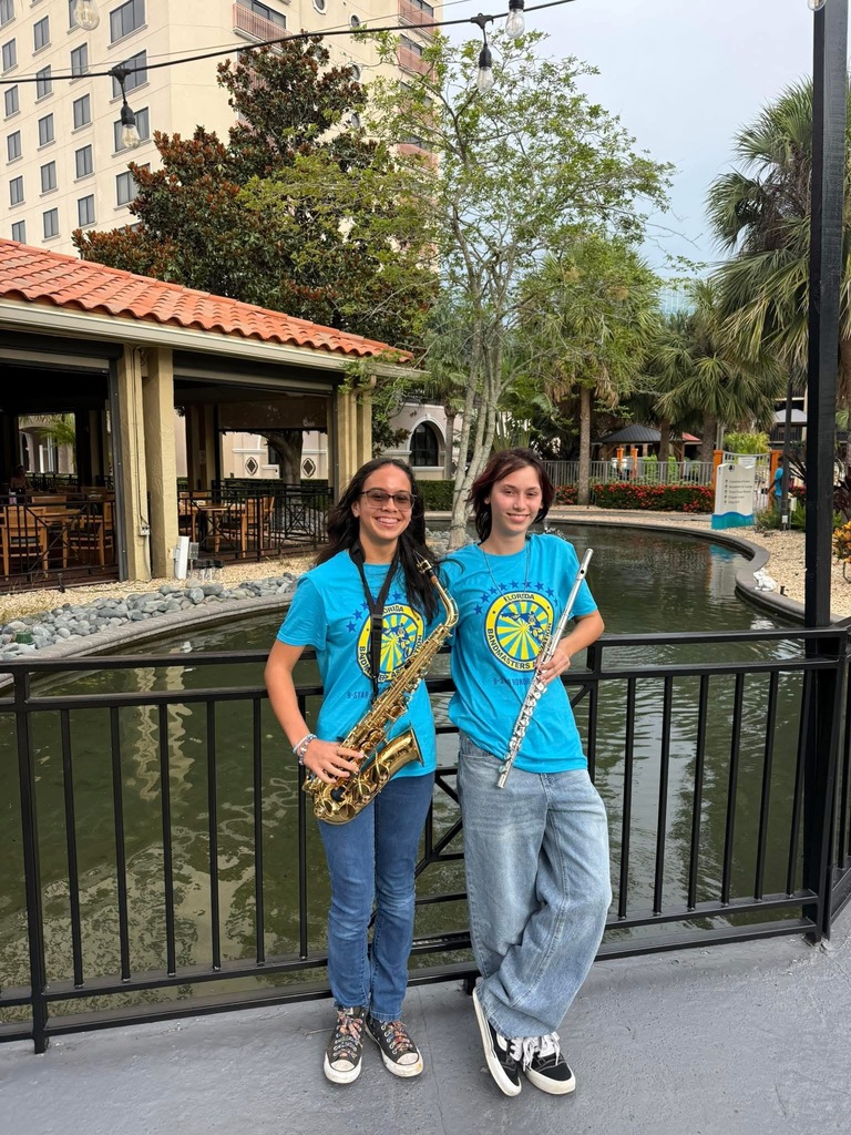 Ana and Liz stand proudly with their instruments