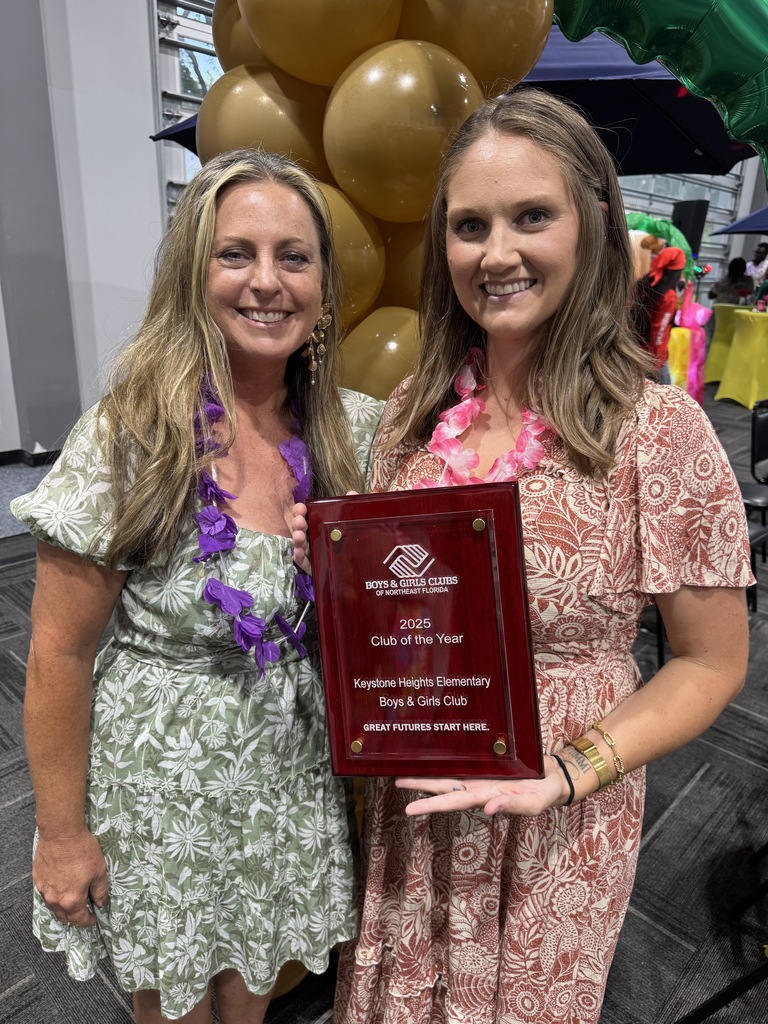Two staff members receiving the Club of the Year Award