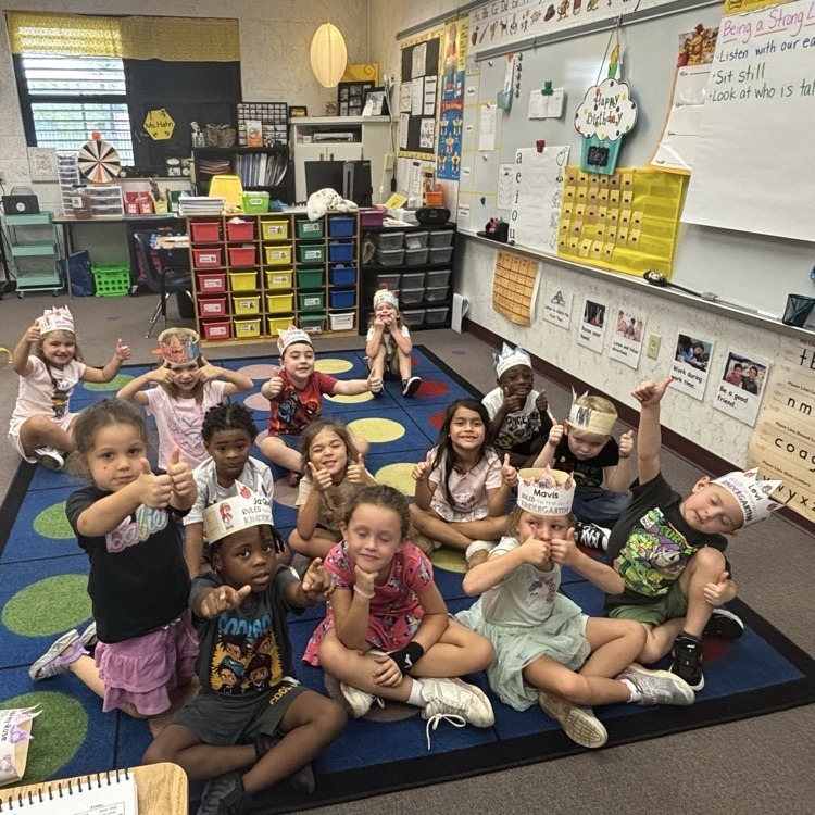 Students sitting on rug in kindergarten class