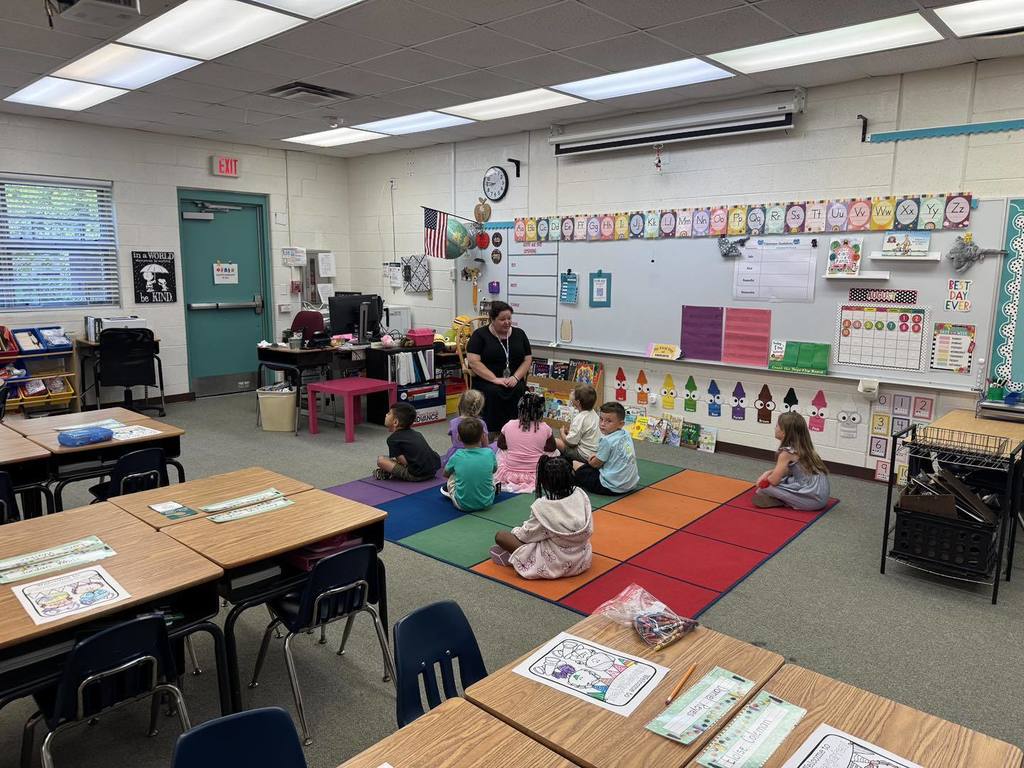 Students sitting on rug in kindergarten class