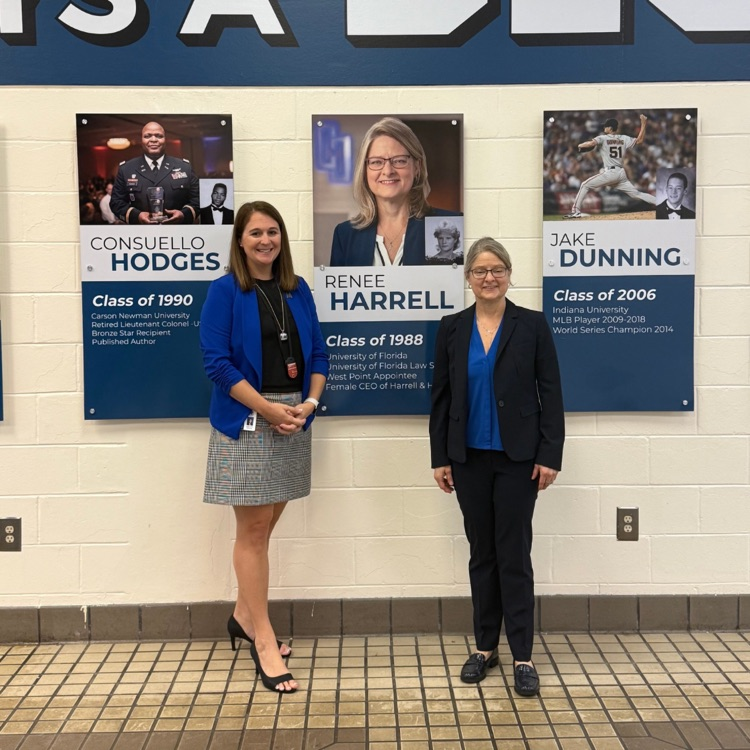 picture of Dr. halter and Renee Harrell in front of hall of fame picture