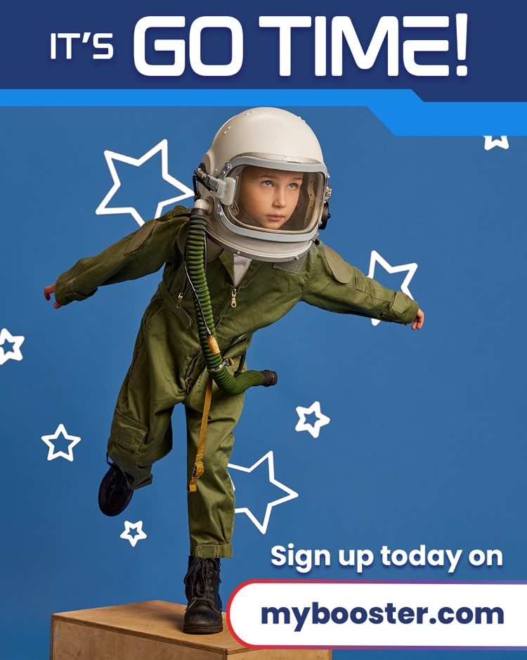 Child wearing space suit, standing on a box