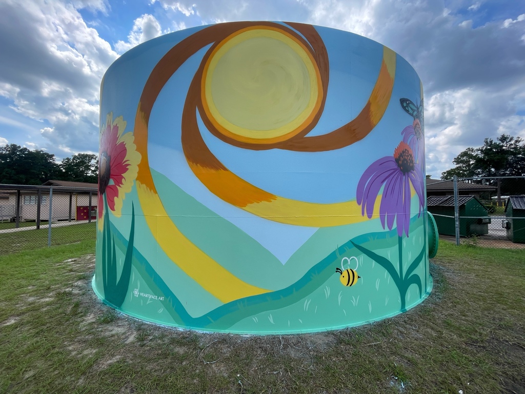 Image of the water tank with a sun painted on the side