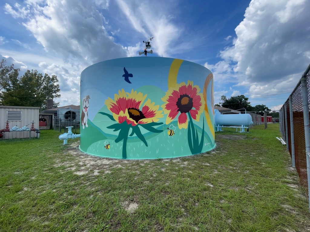 image of a water tank with flowers and bees painted on the side