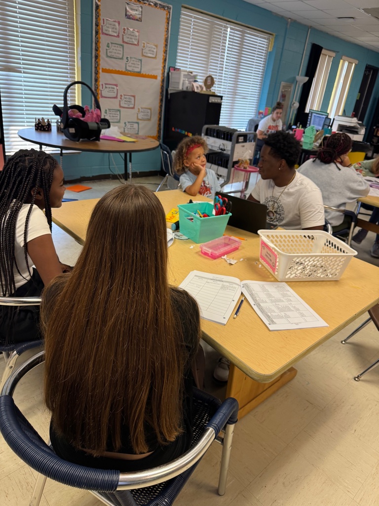 Group of Early Childhood 1 students practicing health check procedures in the classroom.