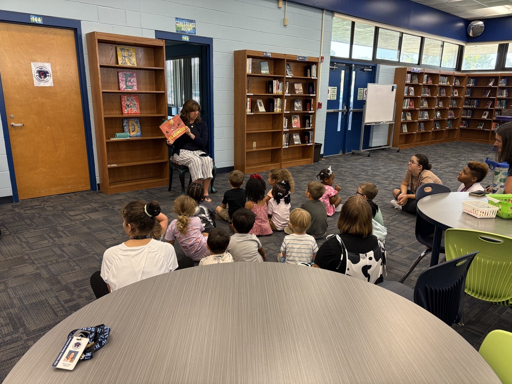 Media Specialist Ms. Pittman reading We Don’t Eat Our Classmates aloud to a group of Little Paws preschoolers.